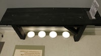 a black bench with four lights on it