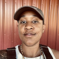 a woman wearing a hat with tattoos