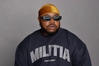 a black man wearing sunglasses and a hat